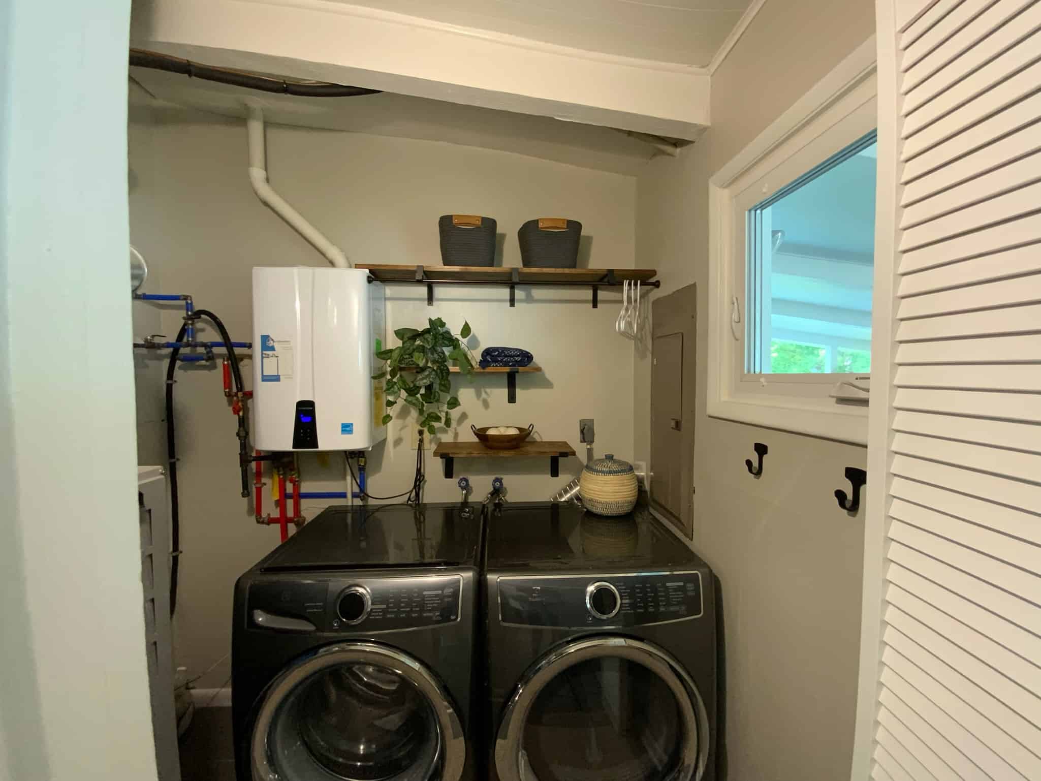 Laundry Room with front load washer and dryer, shelves and hooks