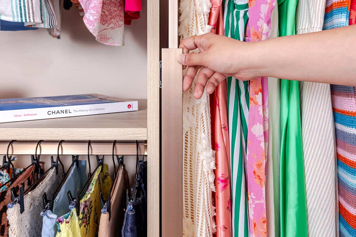 Colorful dress and fabric closet featuring organized hangers and shelves for home storage solutions.